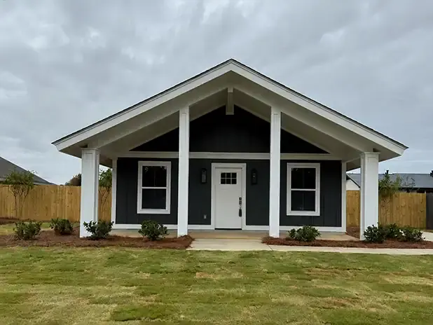 Contemporary house with a stylish gabled roof and manicured lawn.