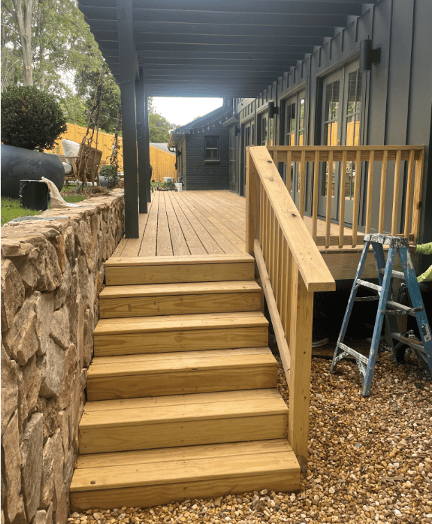 Wooden stairs and deck with stone wall in Birmingham.